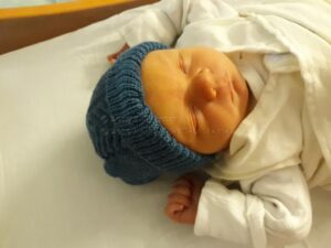 image of caucasian baby wearing knitted hat