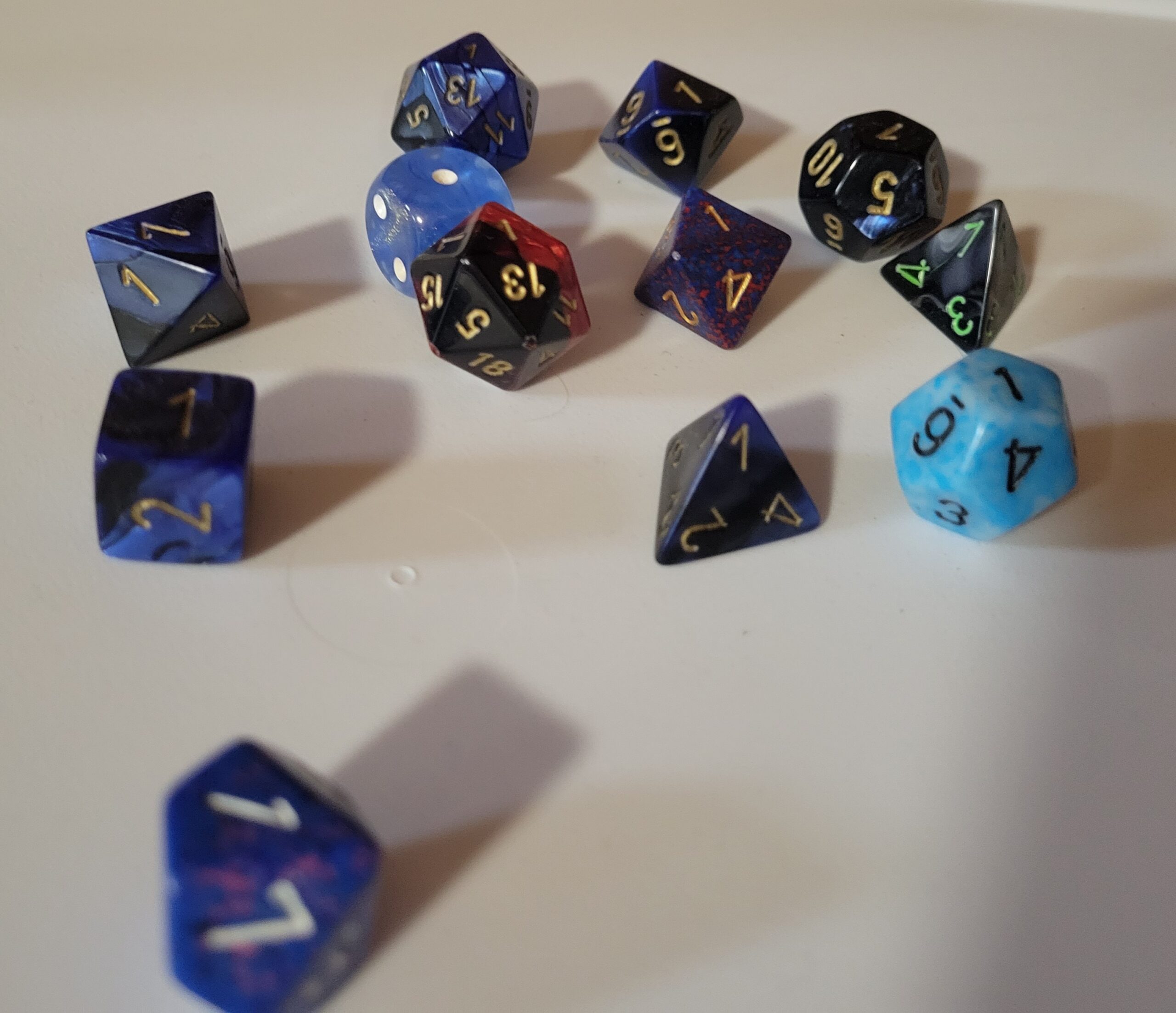 Many shapes of blue dice, all showing that they've rolled the number 1 (except one that accidentally is showing a 7 due to photographer error!)